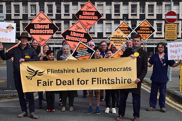 Flintshire Libdems campaigners with a banner demandind a fair deal for Flintshire in front of County Hall